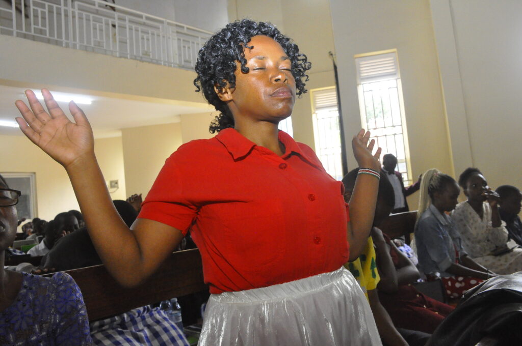 woman in prayer at Entebbe Baptist Church