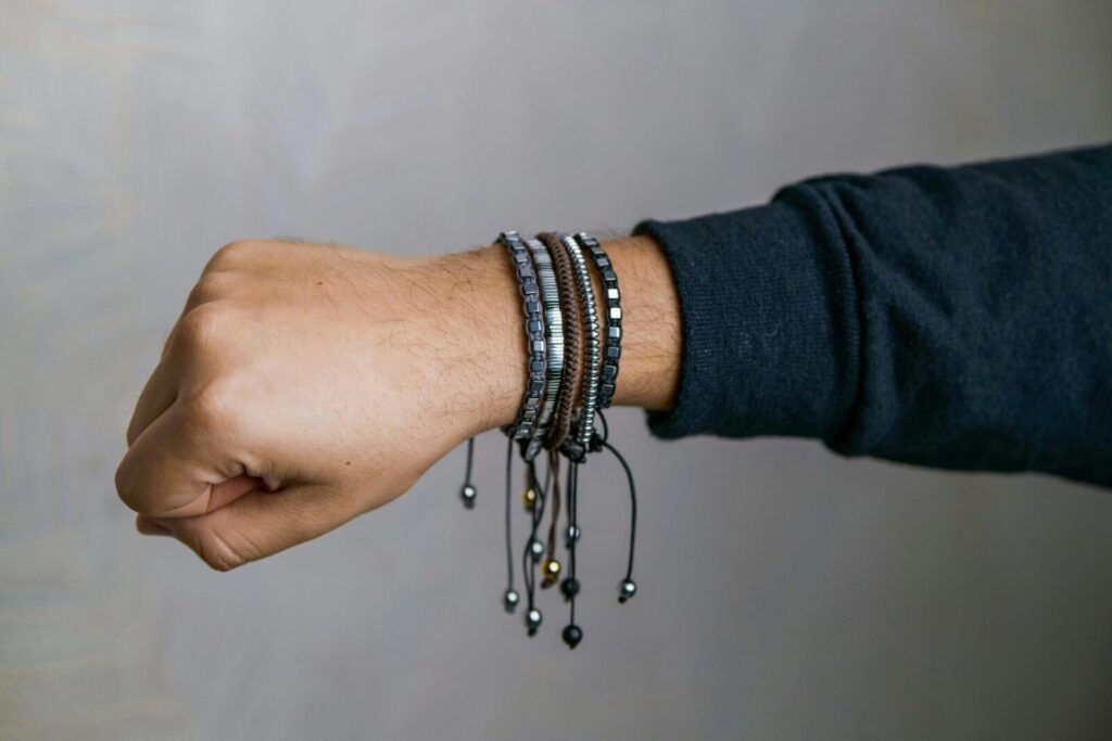 Stylish collection of men's bracelets elegantly displayed on a wrist, showcasing modern fashion accessories.
